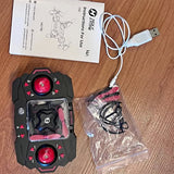 RC drone controller with red circular joysticks and wrist strap, with USB cable