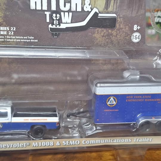 Diecast truck with attached communications trailer, blue cab and silver wheels
