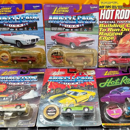 Assorted diecast metal toy cars in blister packaging, various colors