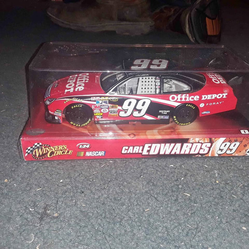 1:24 scale diecast NASCAR collector car, red and black #99 in clear display case