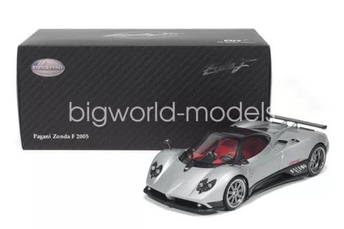 Silver 1:18 metal diecast race car with black accents and red interior, in box