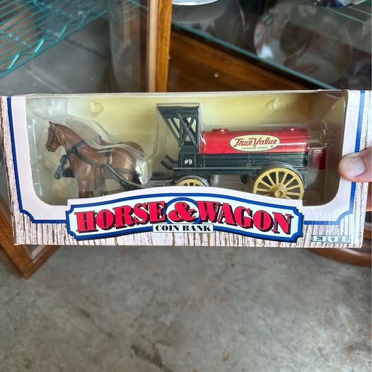 Diecast horse-and-wagon toy in retail box; red wagon and dark horse