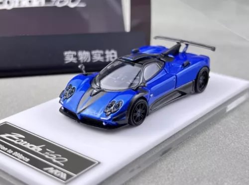 Blue diecast sports car model on white display base, detailed front view