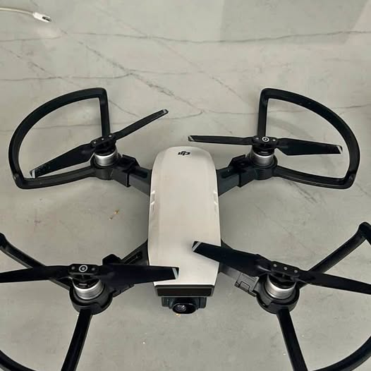 Quadcopter drone with four propellers and front camera, folded arms visible
