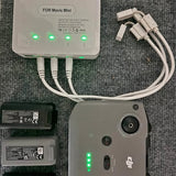 Drone battery charger with LED indicators, cables, and two battery packs