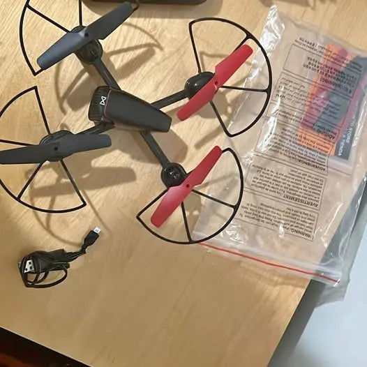 Toy quadcopter drone with red propellers and black body