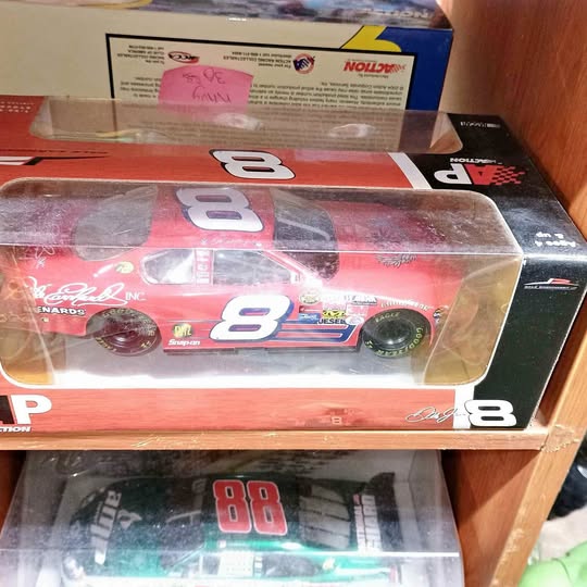 Red diecast race car with large 8 on sides, in clear display box