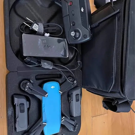 DJI Spark drone in carrying case with controller, cables, and battery