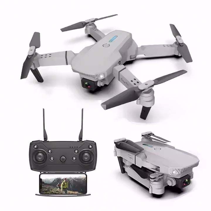 Foldable quadcopter drone with camera, gray body, plus controller and phone screen