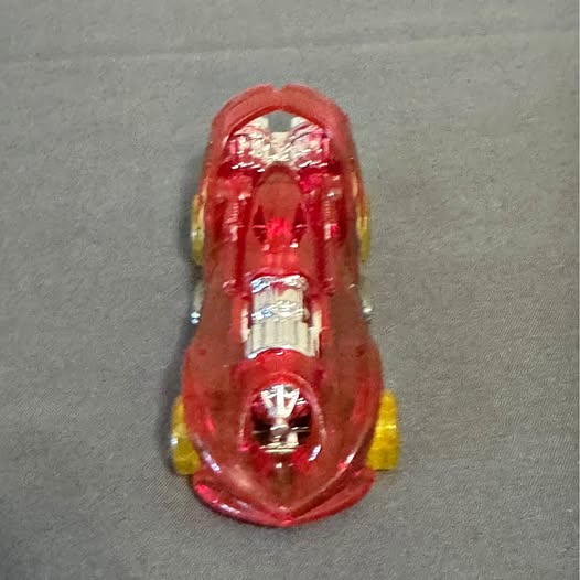 Red see-through die-cast race car, front view with yellow details