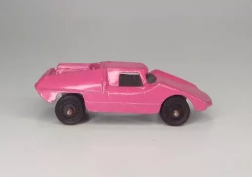 Vintage pink diecast toy coupe car with open hood, side view
