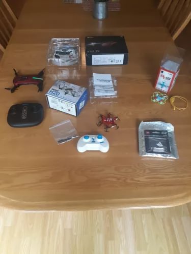 Pocket drone set with small quadcopter, remote controller, and accessory cases and boxes