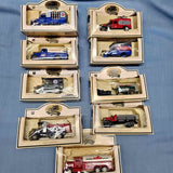 Set of 9 diecast trucks in individual boxes, with blue, red, black, and white models.