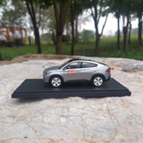Gray 1/43 scale diecast car model with black display base