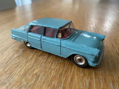 Vintage diecast Opel Kapitan car, light blue body, side view, metal wheels