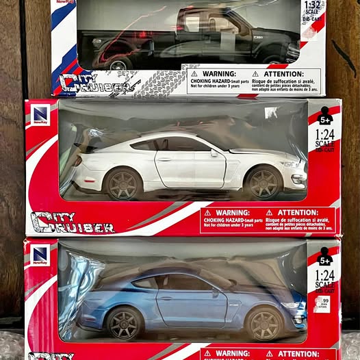 White diecast sports car model in clear retail box with red packaging