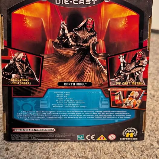 Darth Maul die-cast figure in box, red-and-black face, black robe, lightsaber accessories.