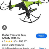 Green and black quadcopter drone with prop guards and four-blade rotor