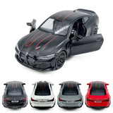 1/36 diecast model car, dark gray coupe with orange racing stripes, front-left view