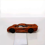 Burnt orange 1:64 diecast model car with black wheels and silver details