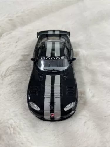 1:36 diecast toy car with black body, white racing stripes, Dodge front view