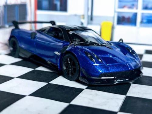 Blue diecast sports car toy with front grille and headlights, black wheels