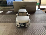 White diecast sedan model car, front view with detailed grille