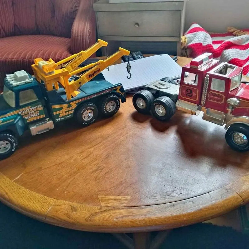 Diecast toy trucks set with yellow, blue, and red vehicles on display