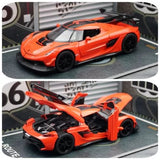 Orange Koenigsegg JESKO diecast toy car with raised doors and black wheels