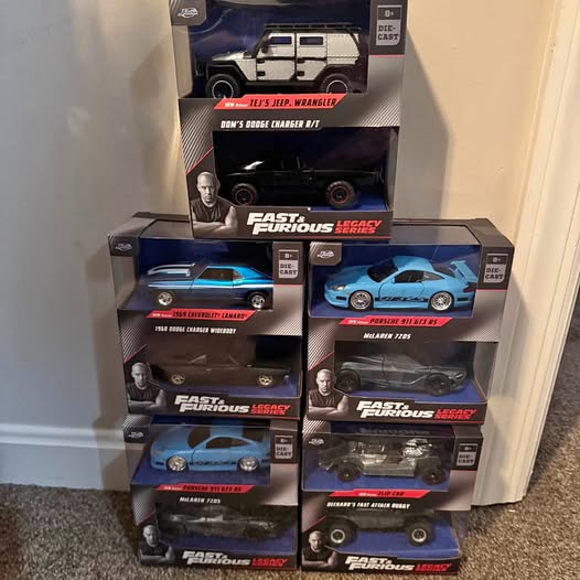 Diecast car set with multiple boxed sports cars, assorted colors, window display