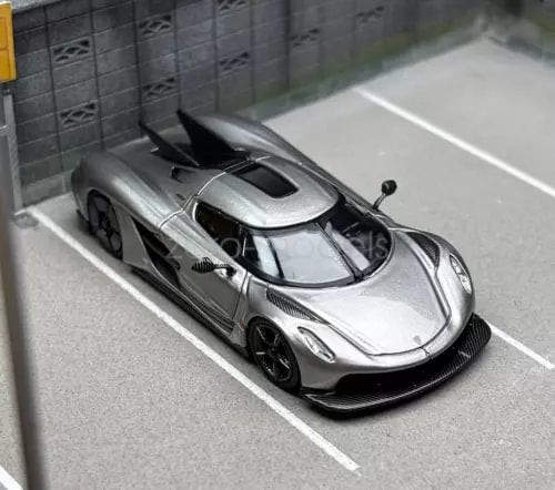 1:64 scale grey diecast sports car with black aero wing and front 3/4 view