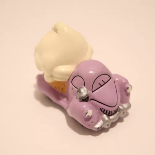 Purple diecast toy ice cream truck with smiling face and white ice cream scoop