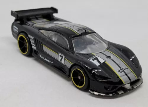 Glossy black diecast race car with yellow wheels and white #7 side stripe