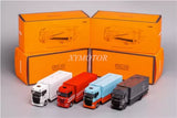 Diecast transport truck model set with four miniature trucks in white, red, blue, and dark gray.