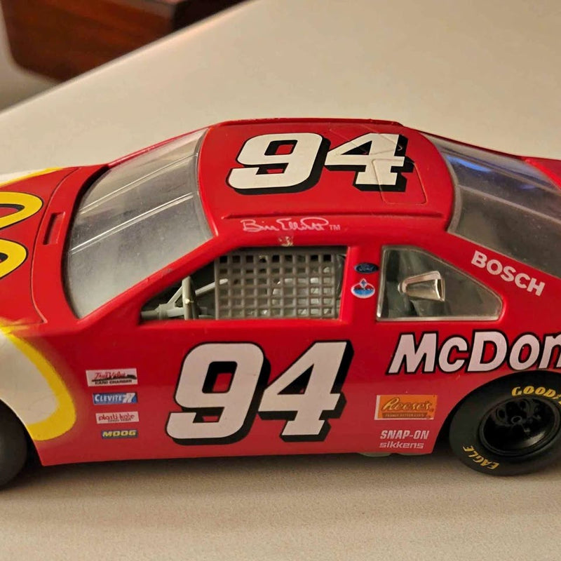 Red diecast NASCAR Ford Thunderbird car, #94 with sponsor graphics, 1:24 scale.