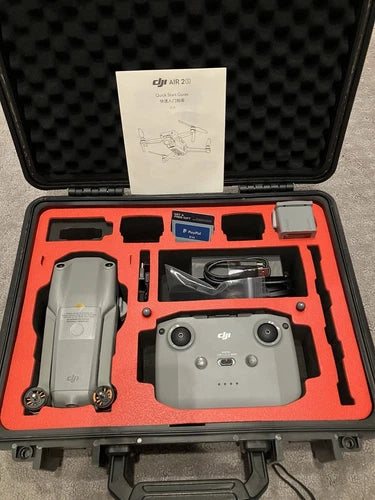 Drone kit in hard case with gray drone and remote controller