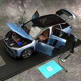 Metallic blue SUV diecast model with open doors and raised hood