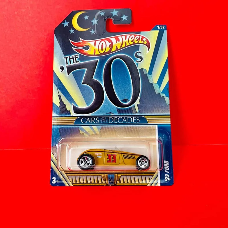 Gold diecast convertible car in blister package, Hot Wheels style graphics, 1/32 scale