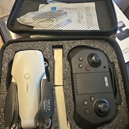 Portable drone remote controller with joysticks, in foam-lined case