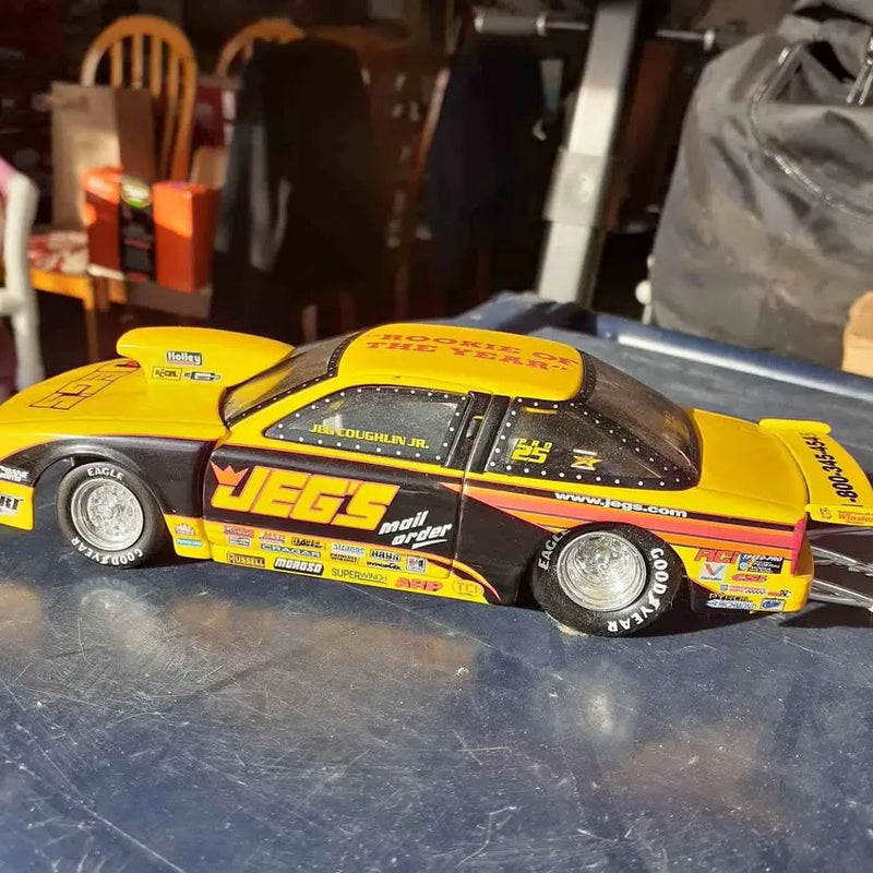 Yellow diecast racing car with number decals and sponsor logos
