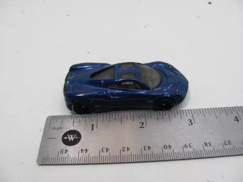 Blue diecast sports car model with black wheels, side view