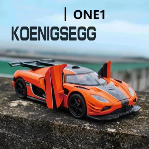 Orange diecast sports car model with black aero details, front 3/4 view