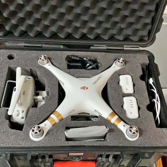 White quadcopter drone with landing gear and four arms, DJI Phantom 3 Professional