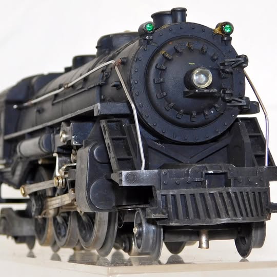 Diecast steam locomotive model with round smokebox door and front headlight, black