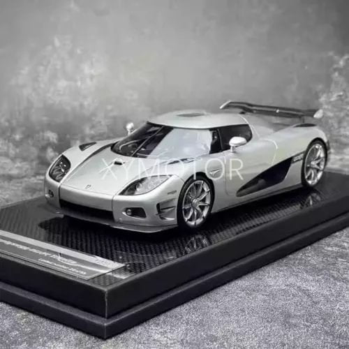 Silver resin diecast model car on display base, front 3/4 view