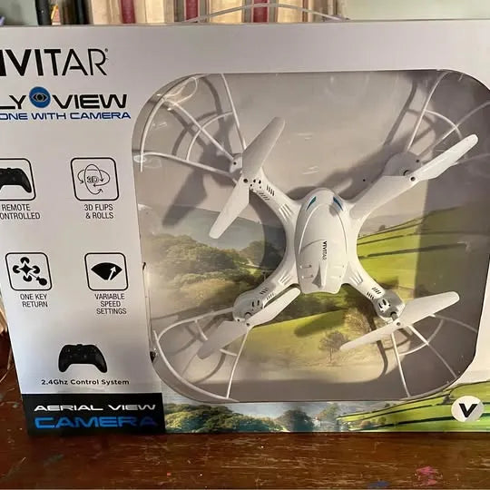 Camera drone in retail box, white quadcopter with four propellers