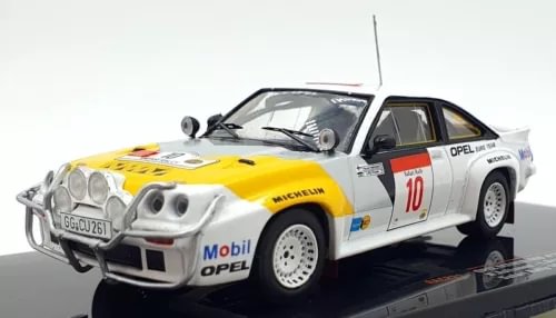 Diecast rally car model, white and yellow with number 10 on side, front three-quarter view.