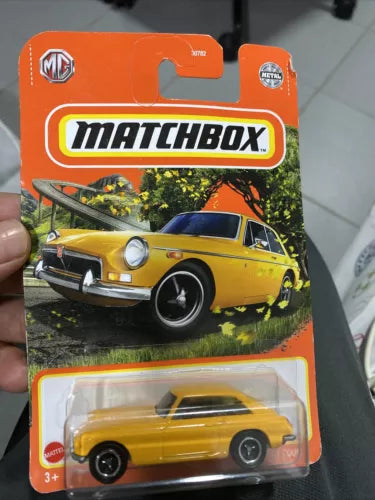 Yellow classic coupe diecast car in Matchbox blister packaging, front view