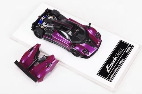 Purple 1/64 scale diecast sports car model toy in open packaging insert