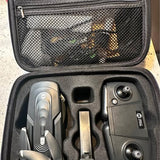 Gray drone and controller in hard case with compartments and accessory pieces